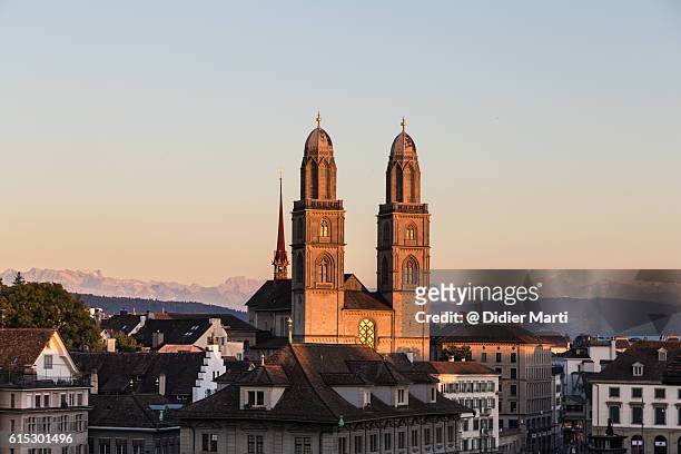 sunset over zurich cathedral - zurich landmark stock pictures, royalty-free photos & images