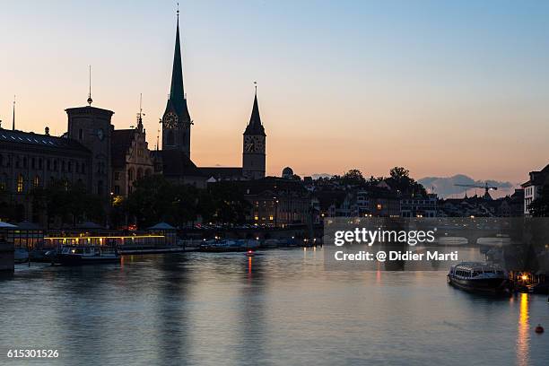 sunset over zurich old town in switzerland - st peters church zurich stock pictures, royalty-free photos & images