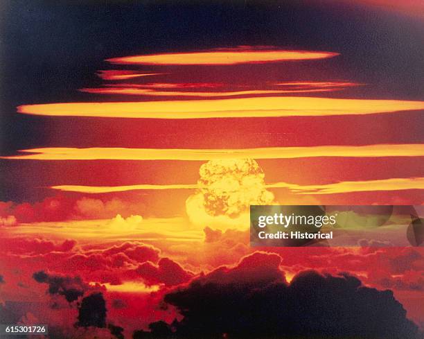 Rings of vapor from the initial blast circle the mushroom cloud of "Dakota" on Bikini Atoll in the Pacific Ocean, 25th June 1956, one of the...