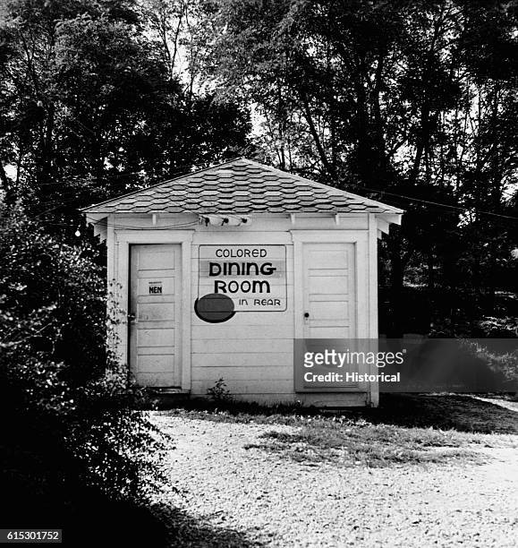 An outhouse at a rest stop between Louisville and Nashville bears a sign directing colored patrons to the dining room behind the outhouse. |...