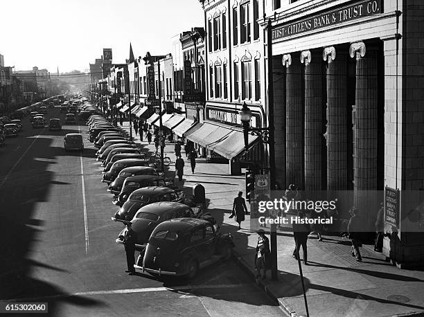 Traffic on the main street of Fayetteville, North Carolina, at five o'clock when workers start leaving Fort Bragg. March 1941.