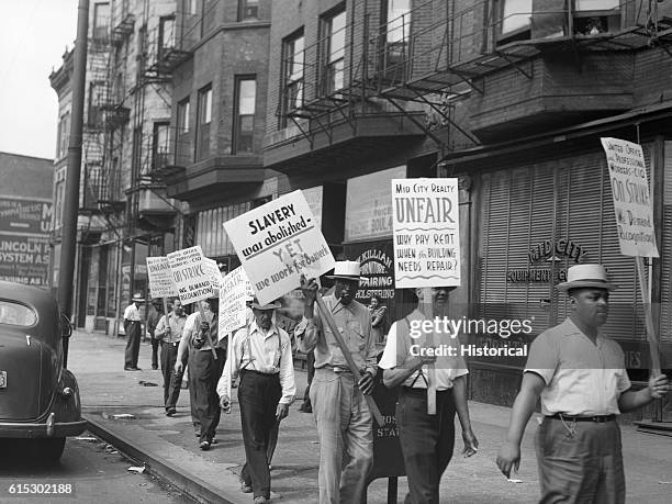 Workers forming a picket line in front of the Mid-City Realty Company in Chicago, Illinois. July 1941.