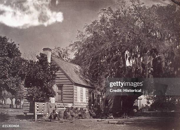Group of freed slaves outside slave quarters on the Elliot Plantation, Hilton Head, South Carolina.