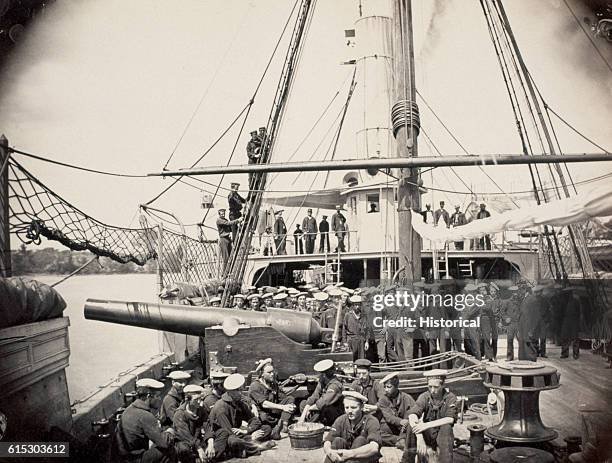 The crew of the Federal warship Mendota on deck during the Civil War. A Parrott gun is pointed over the side. Parrott guns, the first rifled cannon,...