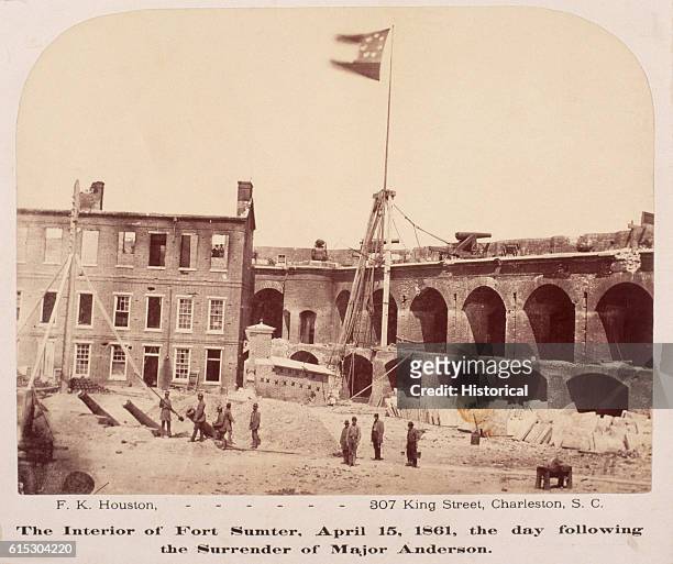 Confederate soldiers stand beneath the Stars and Bars at Fort Sumter, South Carolina, on April 15 the day after the Union surrendered the fort.