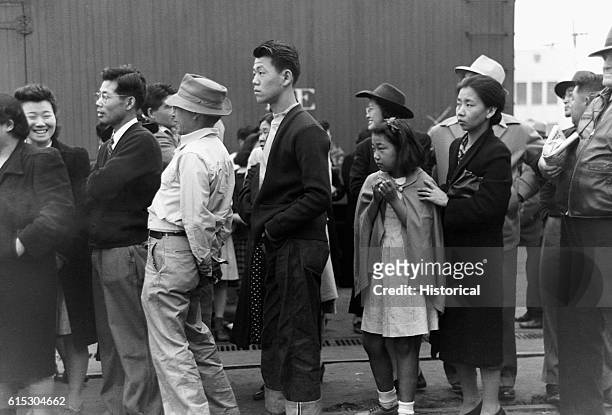 Japanese-Americans in Los Angeles, California, watching a train take their friends and relatives to the Owens Valley internment camp....