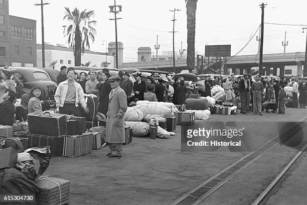 Japanese-Americans waiting in Los Angeles, California, for the train to take them to Manzanar War Relocation Center in Owens Valley, California,...