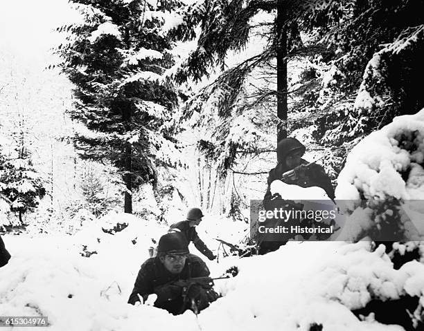 American infantrymen of the 290th Regiment fight in fresh snowfall near Amonines, Belgium during World War II. | Location: near Amonines, Belgium.