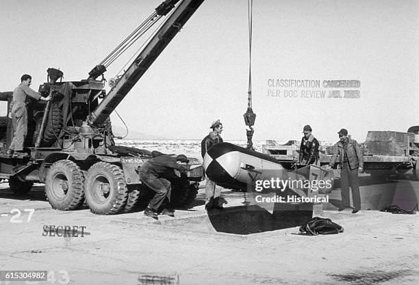 Military Personnel Loading Bomb onto Crane