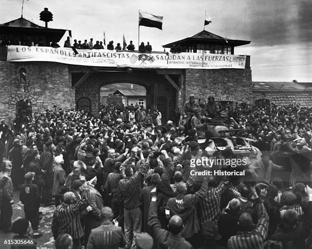 Liberated prisoners in the Mauthausen concentration camp near Linz, Austria, give rousing welcome to Cavalrymen of the 11th Armored Division. The...