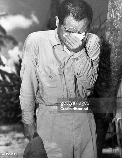 Japanese POW at Guam, with bowed head after hearing Emperor Hirohito make announcement of Japan's unconditional surrender. August 15, 1945.
