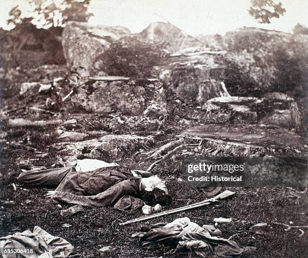 Young, dead Confederate soldier killed in Devil's Den at Gettysburg, Pennsylvania, awaits burial. July 1863. | Location: near Gettysburg,...