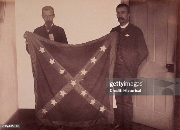 Colonel D.H. Lee Martz of the 10th Virginia Infantry Regiment, Army of Northern Virginia, displays the unsullied battle flag of his old regiment...