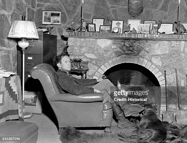 Joseph Matthews, Osage council member, author, historian, and Rhodes scholar, seated at home in front of his fireplace. Oklahoma, December 16, 1937.