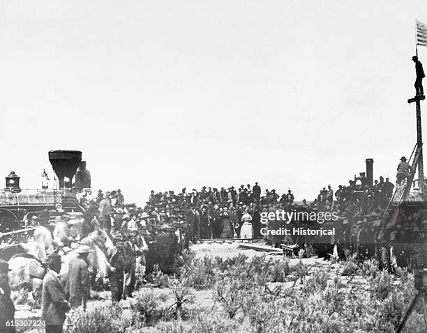 Crowd gathers to see the joining of the tracks for the first transcontinental railroad in Promontory, Utah, Territory in 1869.