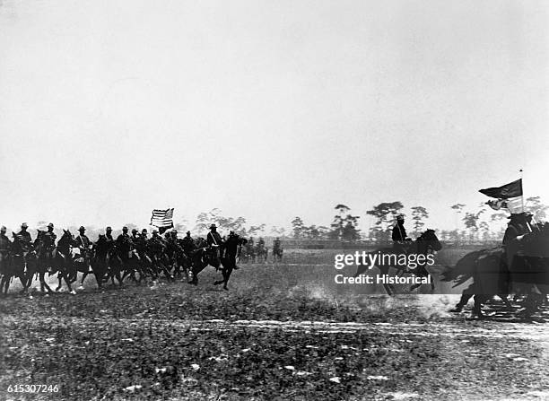 Color bearers lead an attack by the U.S. Third Cavalry during the Spanish-American War in 1898.