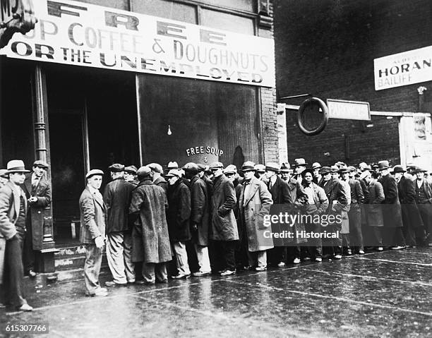 Unemployed men line up outside a Great Depression-era soup kitchen opened in Chicago by Al Capone. The storefront sign reads "Free Soup, Coffee and...