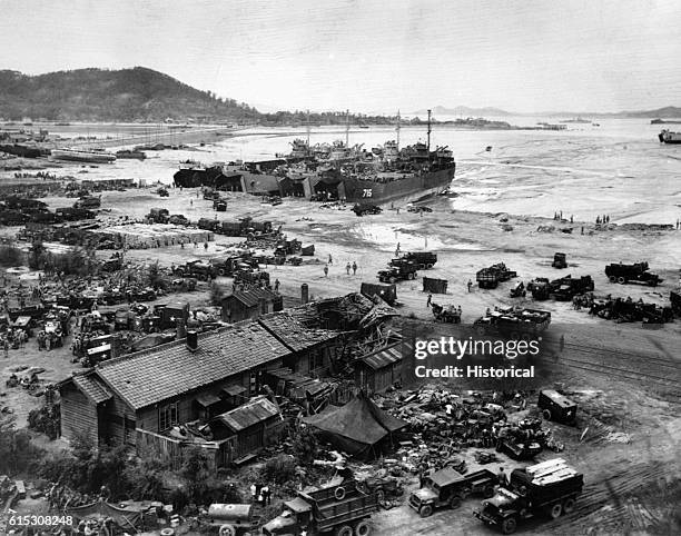 Four LST's unload men and equipment on a Korean beach during the invasion of Inchon, on September 15, 1950. Three of the LST's shown are LST-611,...