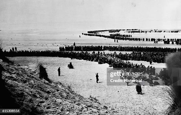 British and French troops await a hurried evacuation from the beaches at Dunkirk, France, in June 1940. German forces were rapidly advancing towards...