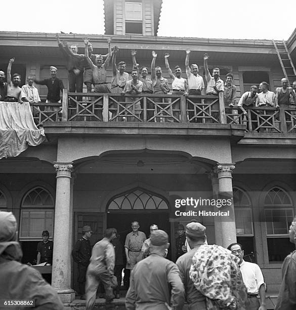 Allied prisoners cheer the arrival of Navy and Marine personnel at a Franciscan convent used as a prison in Saitama prefecture, north of Tokyo....