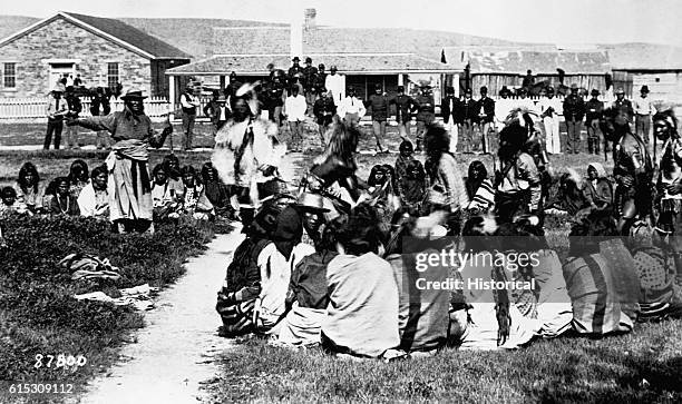 Shoshone at Fort Washakie, Wyoming. Last photograph of Chief Washakie, who is on the extreme left, standing and pointing, 1892.