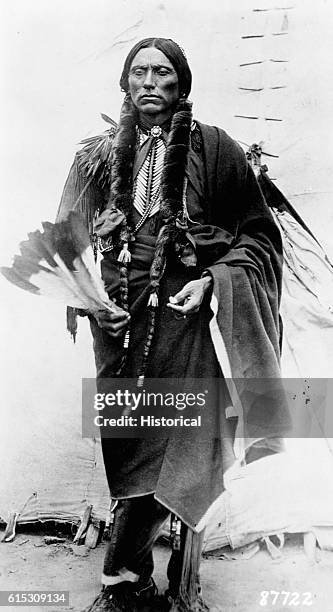 Quanah Parker, a Kwahadi Comanche chief; full-length, standing in front of tent. | Location: outdoors.
