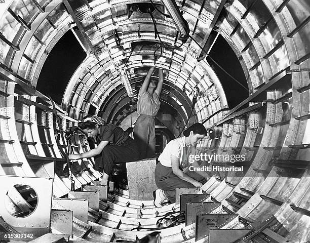 Women workers assemble the tail fuselage of a B-17F bomber, a "Flying Fortress" at the Douglas Aircraft Company in Long Beach, California.