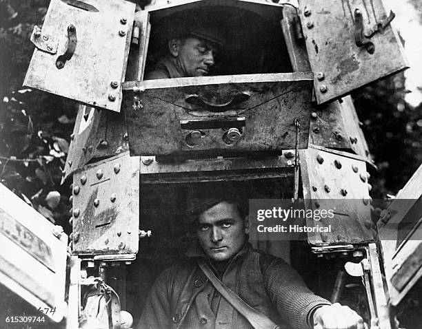 Skipper and gunner sit in a "whippet" tank, with the hatches open northwest of Verdun, France in 1918. | Location: northwest of Verdun, France.