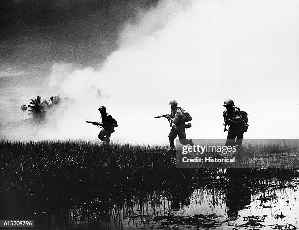Crack troops of the South Vietnamese Army in combat operations against the Communist Viet Cong guerillas. Swampy terrain of the delta country makes...
