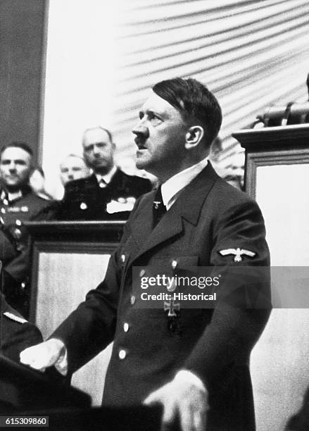 Adolf Hitler rises before the Reichstag on September 1 to declare war on Poland.