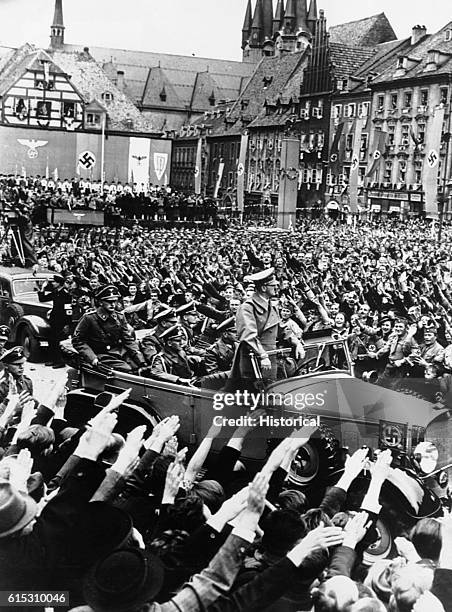 Hitler enters the Czech city of Eger surrounded by a saluting crowd. Ca. 1939-1945. | Location: Eger, Czechoslovakia.