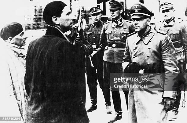 General-SS Jurgen Stroop questions Jews during the razing of the Warsaw ghetto. 1939.