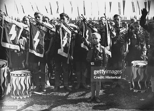 Crowd of Hitler Youth give the "Heil Hitler" salute. The boys are attending Hitler Youth Day at one of the Nuremberg rallies, ca. 1930s.