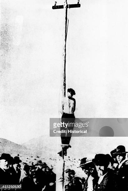 The lynching of John Heith at Tombstone, Arizona. He was implicated in the robbery of the Goldwater-Castaneda store in December 1883, during which...