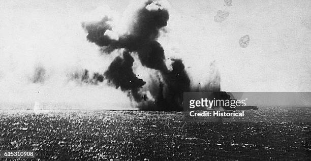 Navy torpedo planes attack the Japanese Aircraft CarrierShoho, during the battle of the Coral Sea. Two Navy torpedo planes circle the carrier. One is...