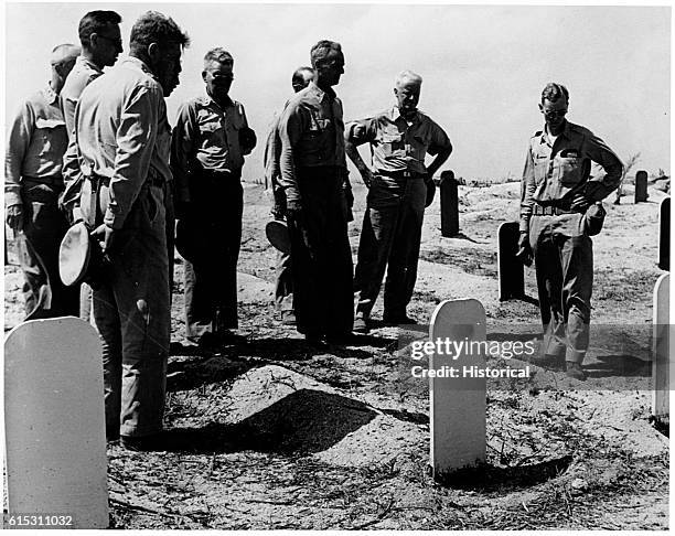 Admiral Chester Nimitz visits the Marine cemetery on Namur during his visit there February 6, 1944. Col. Frank Hartand and Major General Harry...