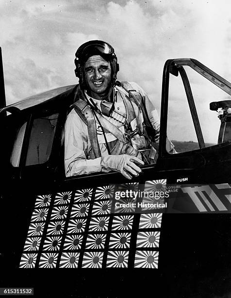 Commander David McCampbell, USN, in cockpit of F6F. Showing flags denoting his 30 Japanese planes shot down, aboard USS Essex. | Location: cockpit of...