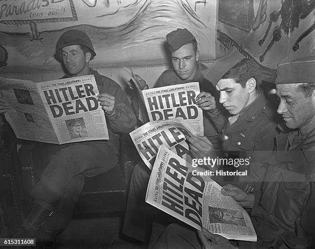 American GIs on leave in Paris reading the U.S. Military newspaper Stars and Stripes, which has a headline announcing Hitler's death. The German...