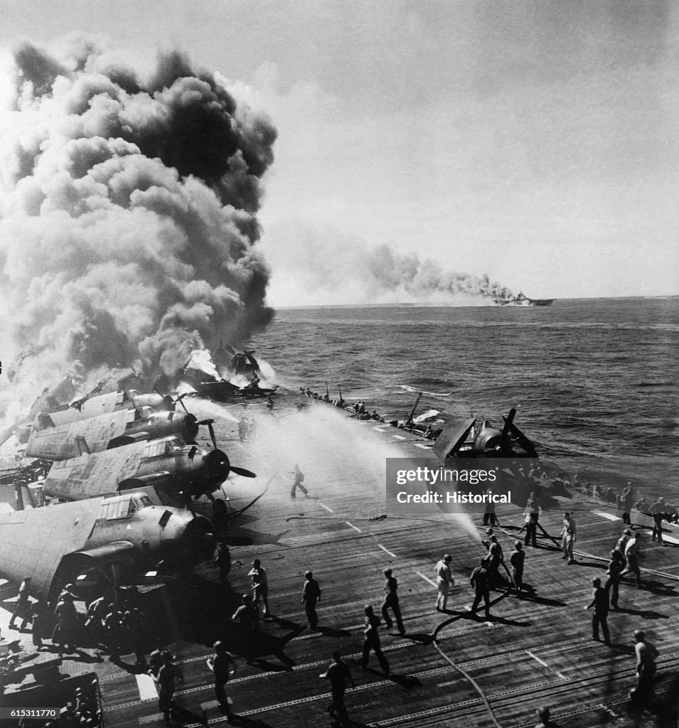 Crew Members Putting Out Fire Aboard Aircraft Carrier
