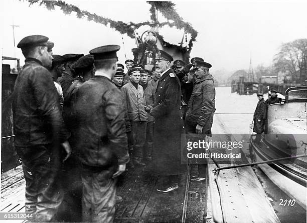 Prince Henry of Prussia says farewell to a submarine crew about to depart.