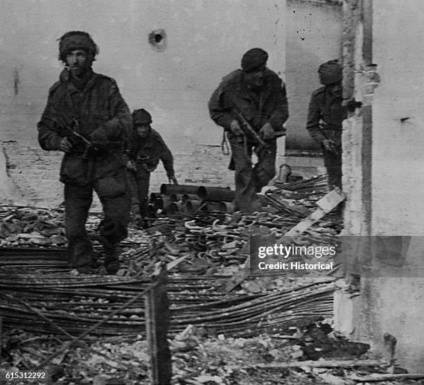 British paratroopers search for German troops during Operation Market-Garden, during which the Allies dropped almost 9,000 paratroopers behind German...