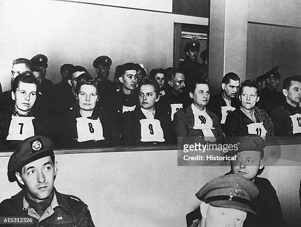 Numbers identify prisoners in the dock during a war crimes trial in Luneberg, Germany. Among the prisoners are a number of women, including Elizabeth...