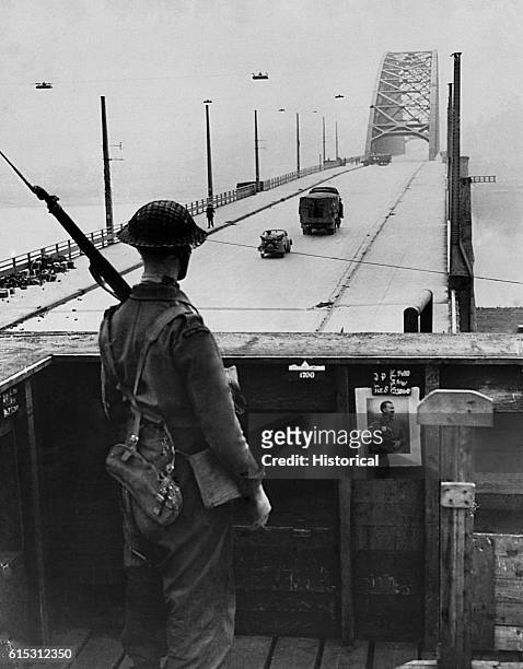 Soldier stands guard at the bridge at Nijmegen, the Netherlands, captured intact by Allied forces during Operation Market-Garden. September 21, 1944.