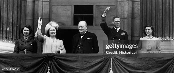 Prime Minister Winston Churchill appears on the balcony at Buckingham Palace together with King George VI and Queen Elizabeth and the two princesses...
