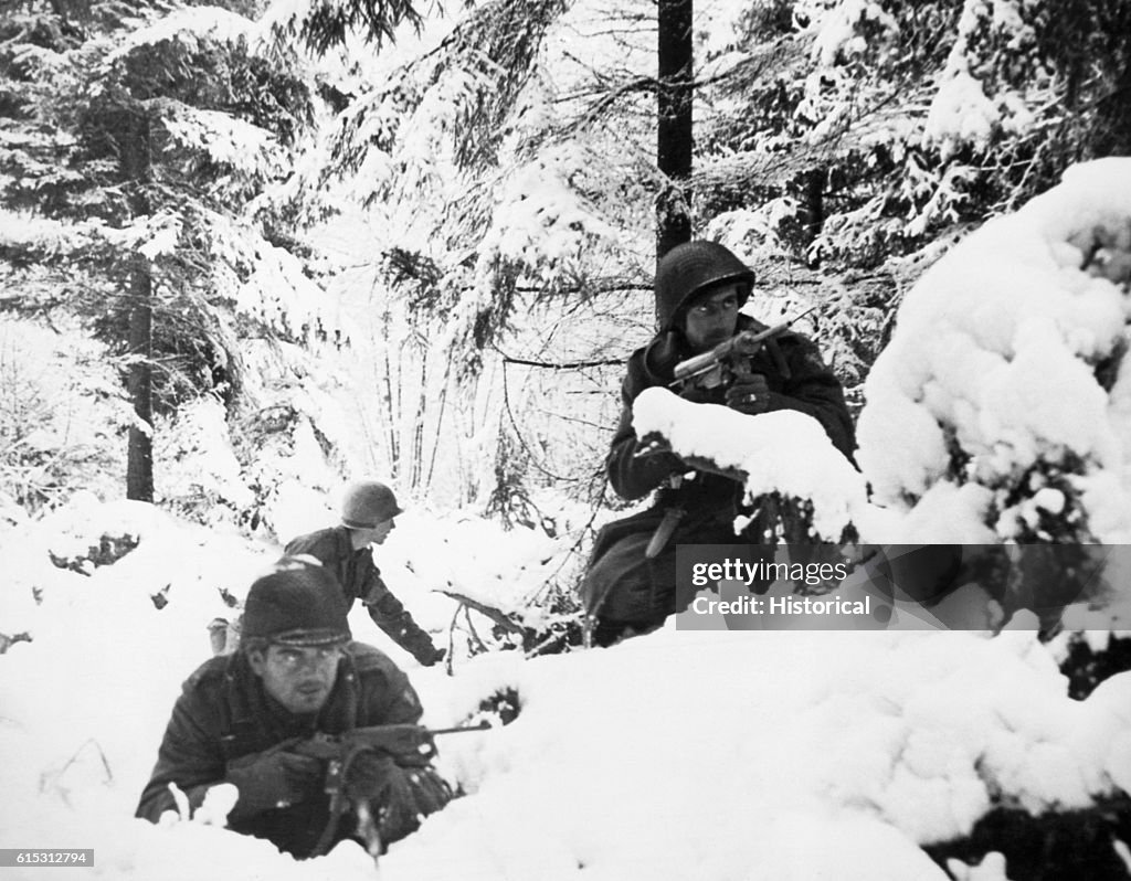 U S Troops In A Snow Covered Forest During The Battle Of The Bulge u-s-troops-in-a-snow-covered-forest-during-the-battle-of-the-bulge