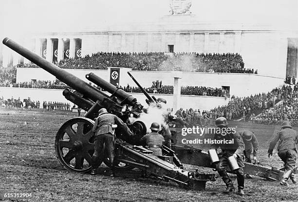 German soldiers demonstrate firing a cannon for the 1937 Nuremberg Rally's "Army Day".