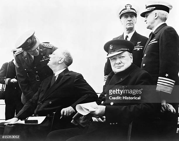 British Prime Minister Winston Churchill and U.S. President Franklin D. Roosevelt meet aboard a battleship cruising the Atlantic Ocean for the...