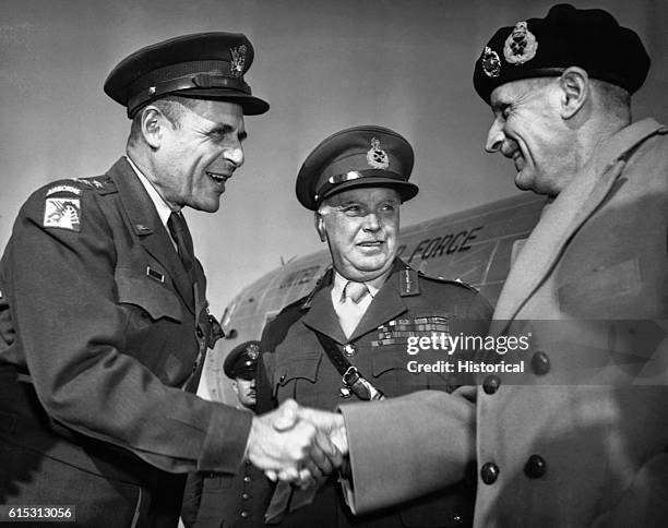 Lieutenant General Matthew Ridgeway of the U.S. Army Air Force greets Field Marshal Bernard Montgomery while General Sir Frederick Morgan looks on....
