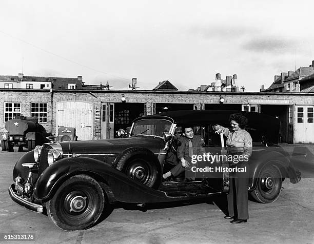 Soldier steps out of Nazi leader Heinrich Himmler's car.