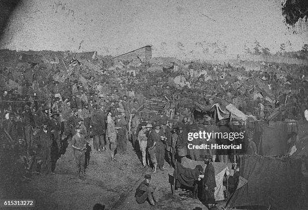 Union prisoners are waiting to draw rations at the main gate of Andersonville prison in Georgia during the U.S. Civil War.